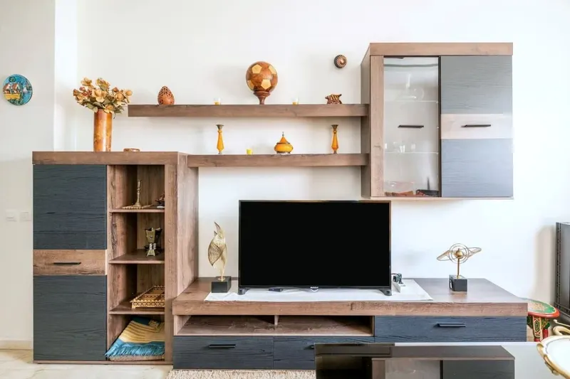 TV wall unit in walnut and grey with brass and copper ornaments